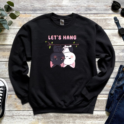 a black sweatshirt with a picture of a cat and a dog hanging from a tree