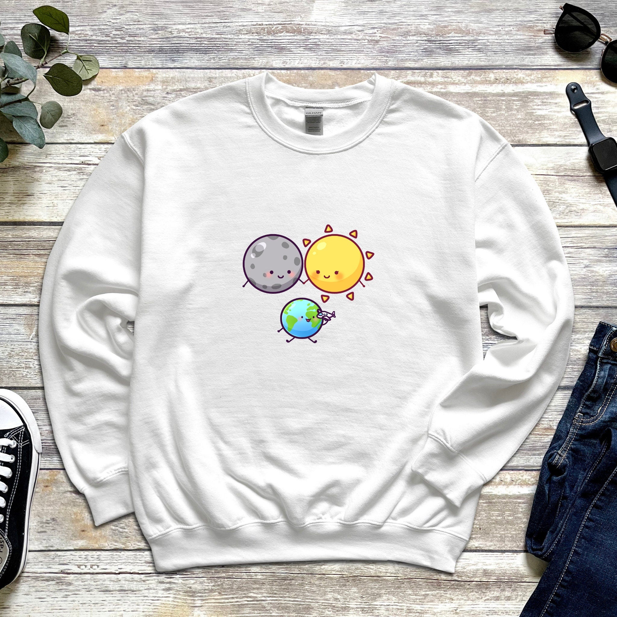 a white sweatshirt with the sun and moon on it