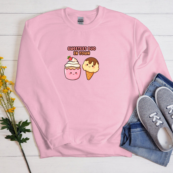 a pink sweatshirt with an ice cream cone and a donut on it