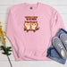 a pink sweatshirt with two owls on it