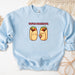 a blue sweatshirt with two burritos on it
