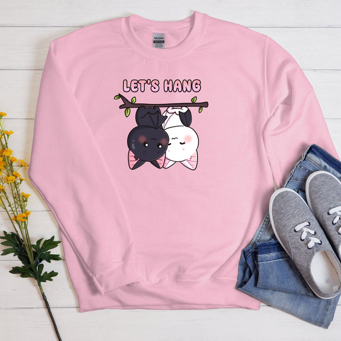 a pink sweatshirt with a dog and cat on it
