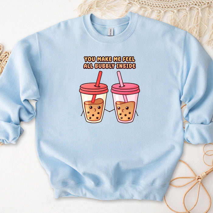 a blue sweatshirt with two cups of cookies and a straw