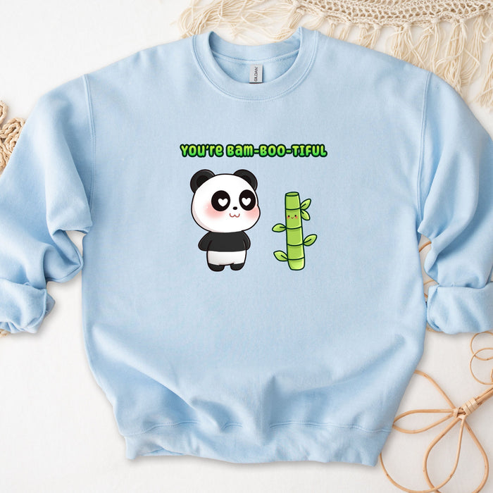 a blue sweatshirt with a panda holding a green cactus