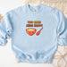 a blue sweatshirt with a bowl of cereal on it