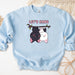 a blue sweatshirt with a picture of two dogs hanging on a branch