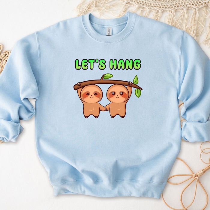 a blue sweatshirt with two slots hanging on a tree branch