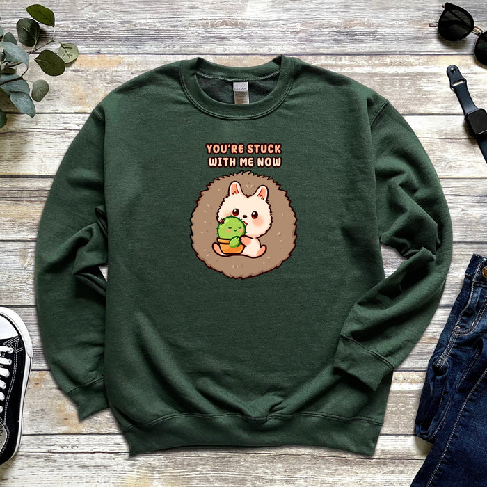 a green sweatshirt with an image of a hedge holding a ball