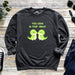 a sweatshirt with a couple of green dinosaurs on it