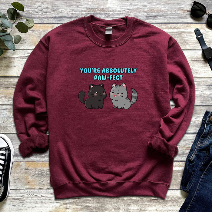 a red sweatshirt with a black cat and a white cat saying you&#39;re absolutely