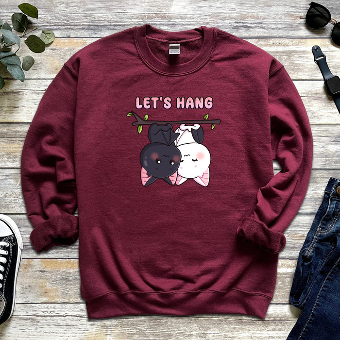 a red sweatshirt with two dogs hanging on a tree branch