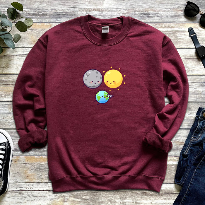 a sweatshirt with an image of a planet and a sun on it
