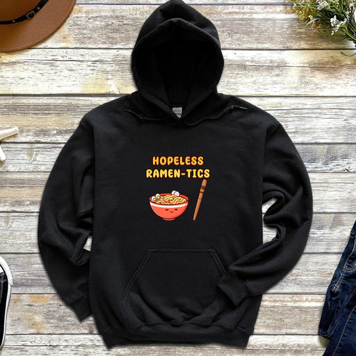 a black hoodie with a bowl of ramen - tics on it