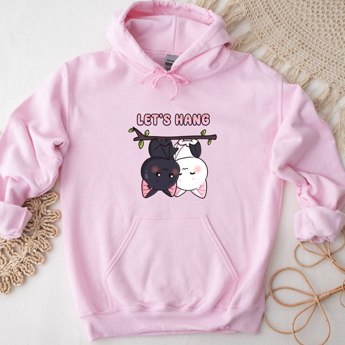 a pink hoodie with a picture of a dog hanging from a tree