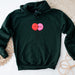 a green hoodie with a pair of balloons on it