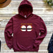 a maroon hoodie with two sushi eyes on it