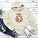 a sweatshirt with a hedge holding a leaf