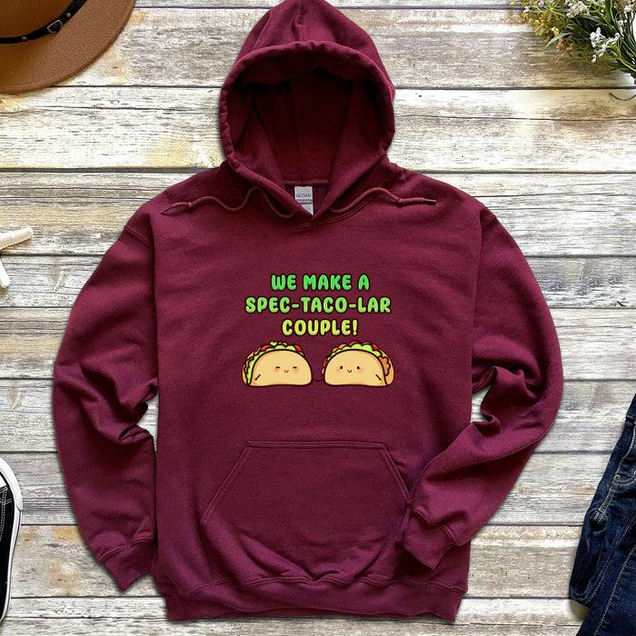 a maroon hoodie that says we make a speech taco - lar couple