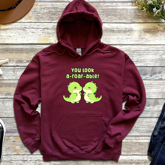 a red hoodie with two green dinosaurs on it