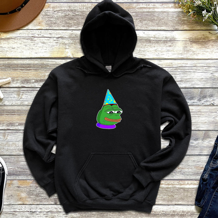 a black hoodie with a green frog wearing a party hat