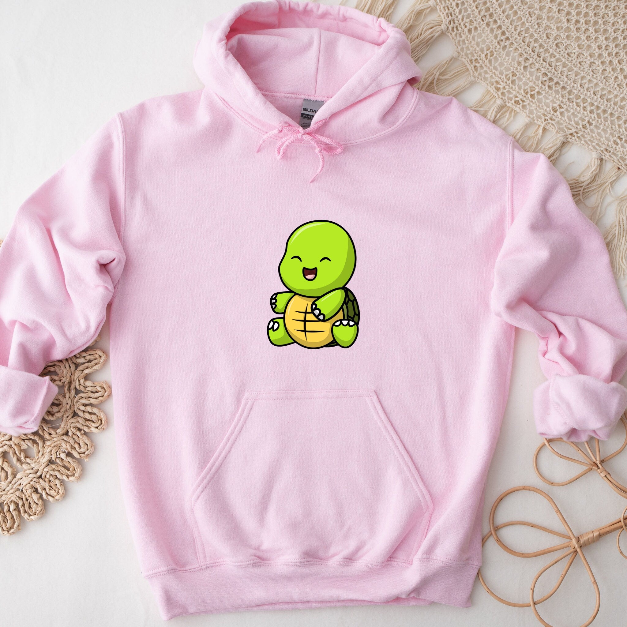 a pink hoodie with a cartoon turtle on it