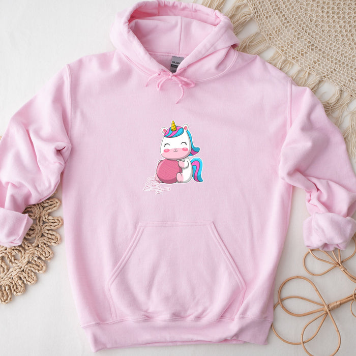 a pink hoodie with a cartoon unicorn on it