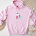 a pink hoodie with a cartoon unicorn on it