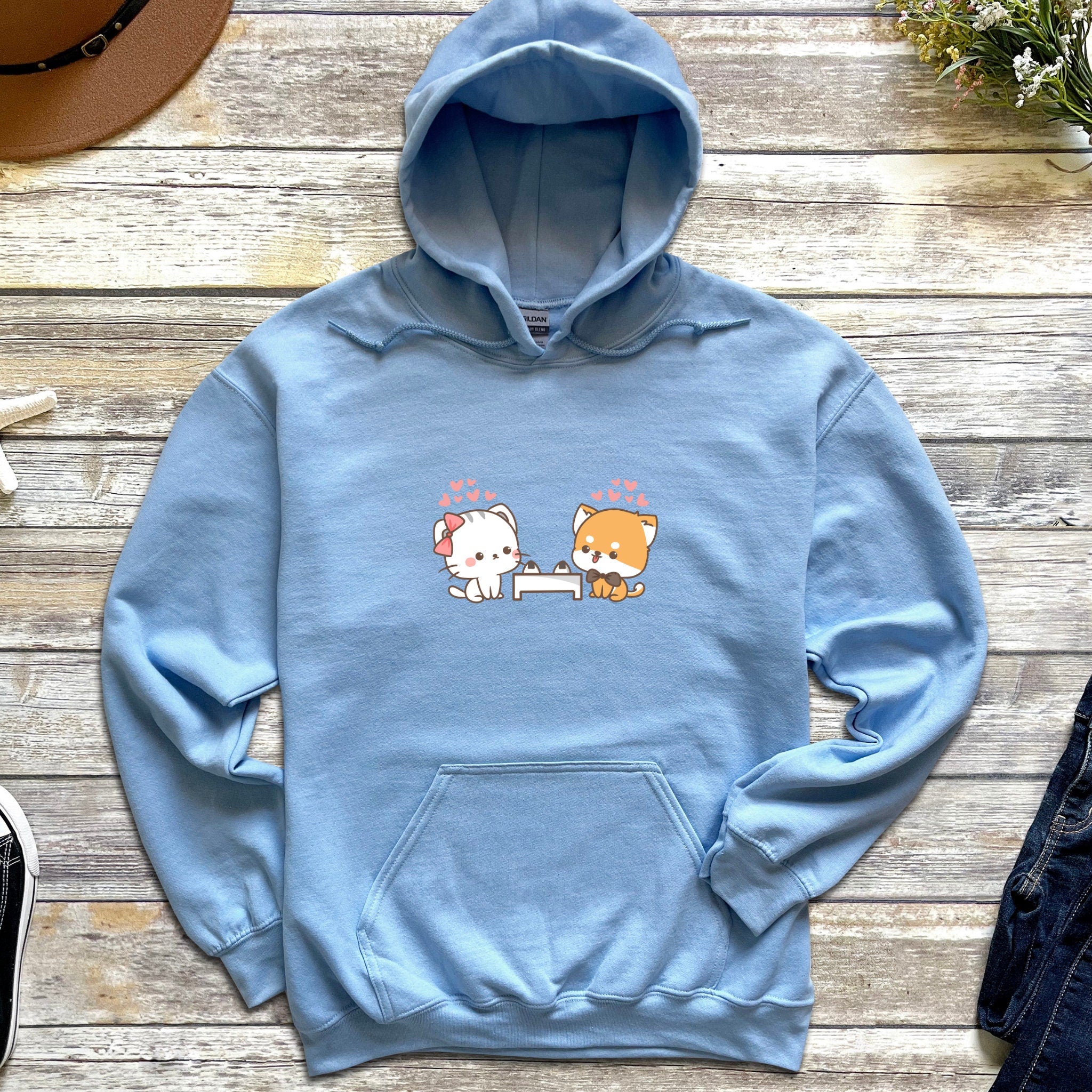 a blue hoodie with two cats on it