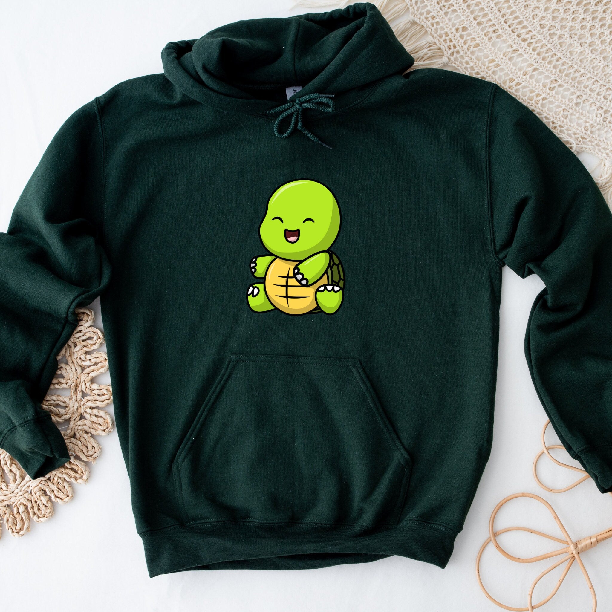 a green hoodie with an image of a turtle on it