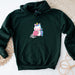 a green sweatshirt with a cartoon unicorn on it