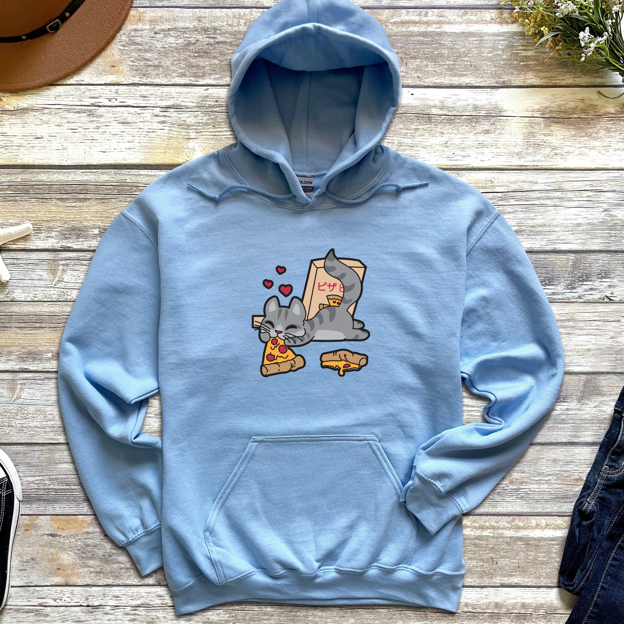 a blue hoodie with a cartoon cat eating a slice of pizza