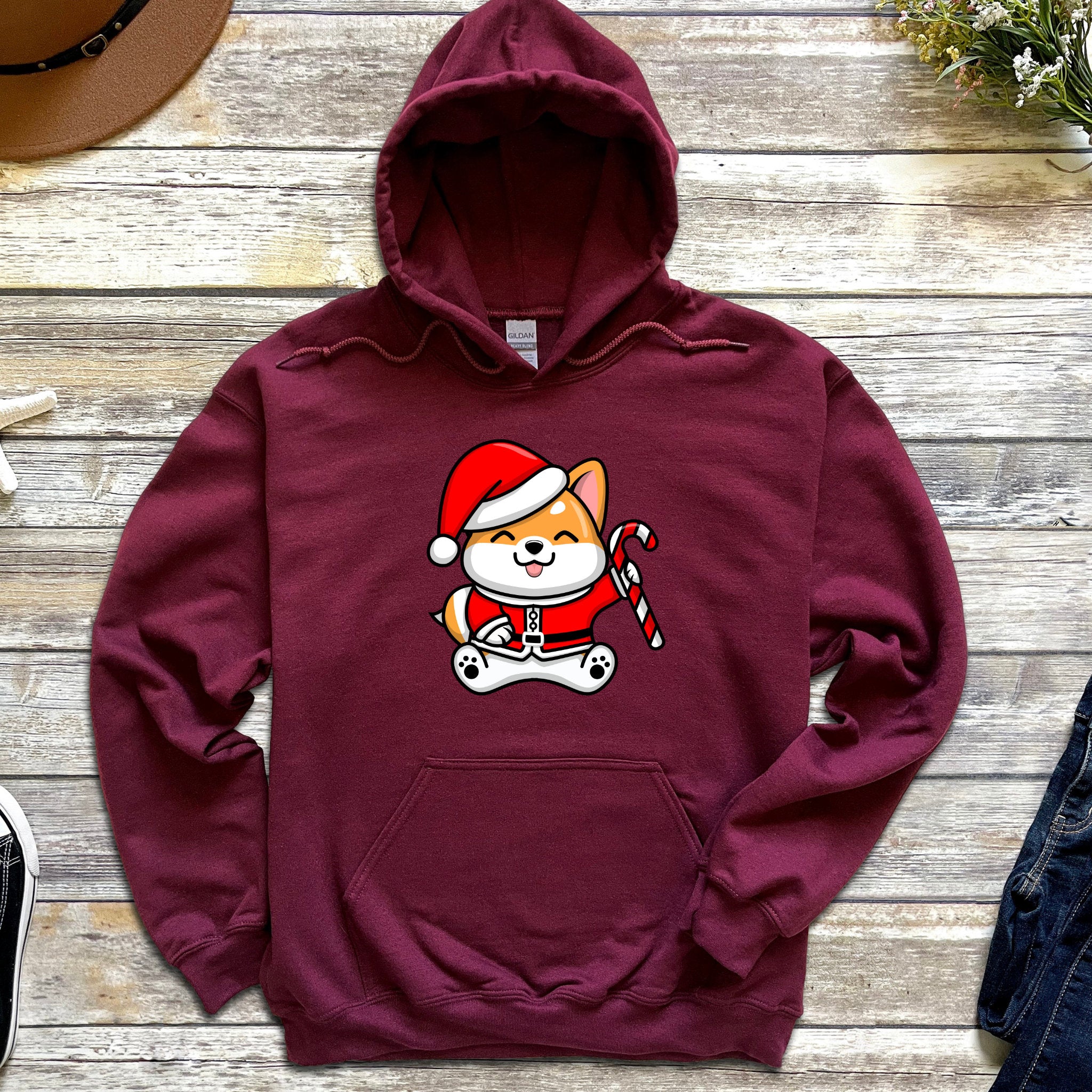 a red hoodie with a cartoon cat wearing a santa hat
