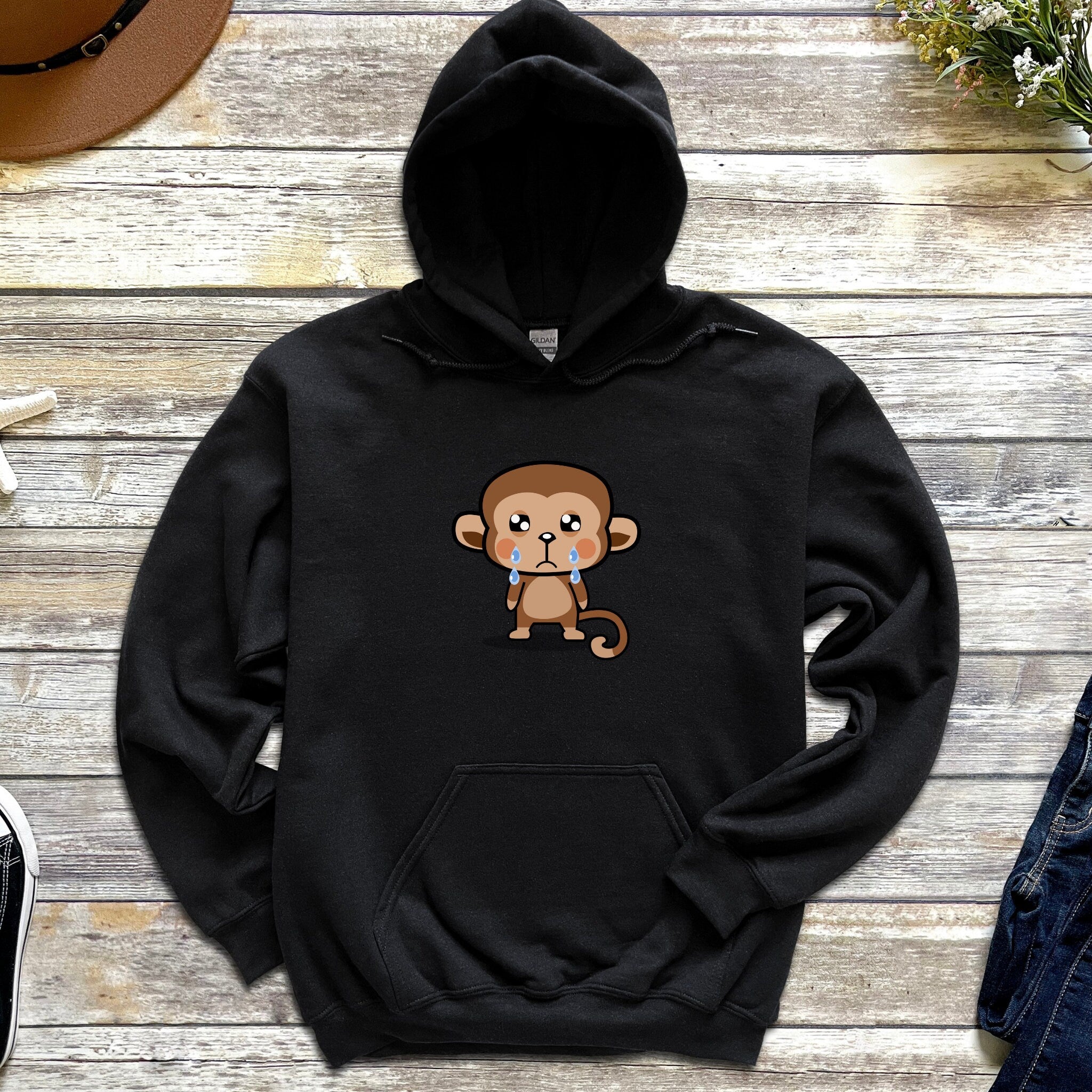 a black hoodie with a cartoon monkey on it