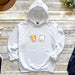a white hoodie with a cartoon cat and dog on it