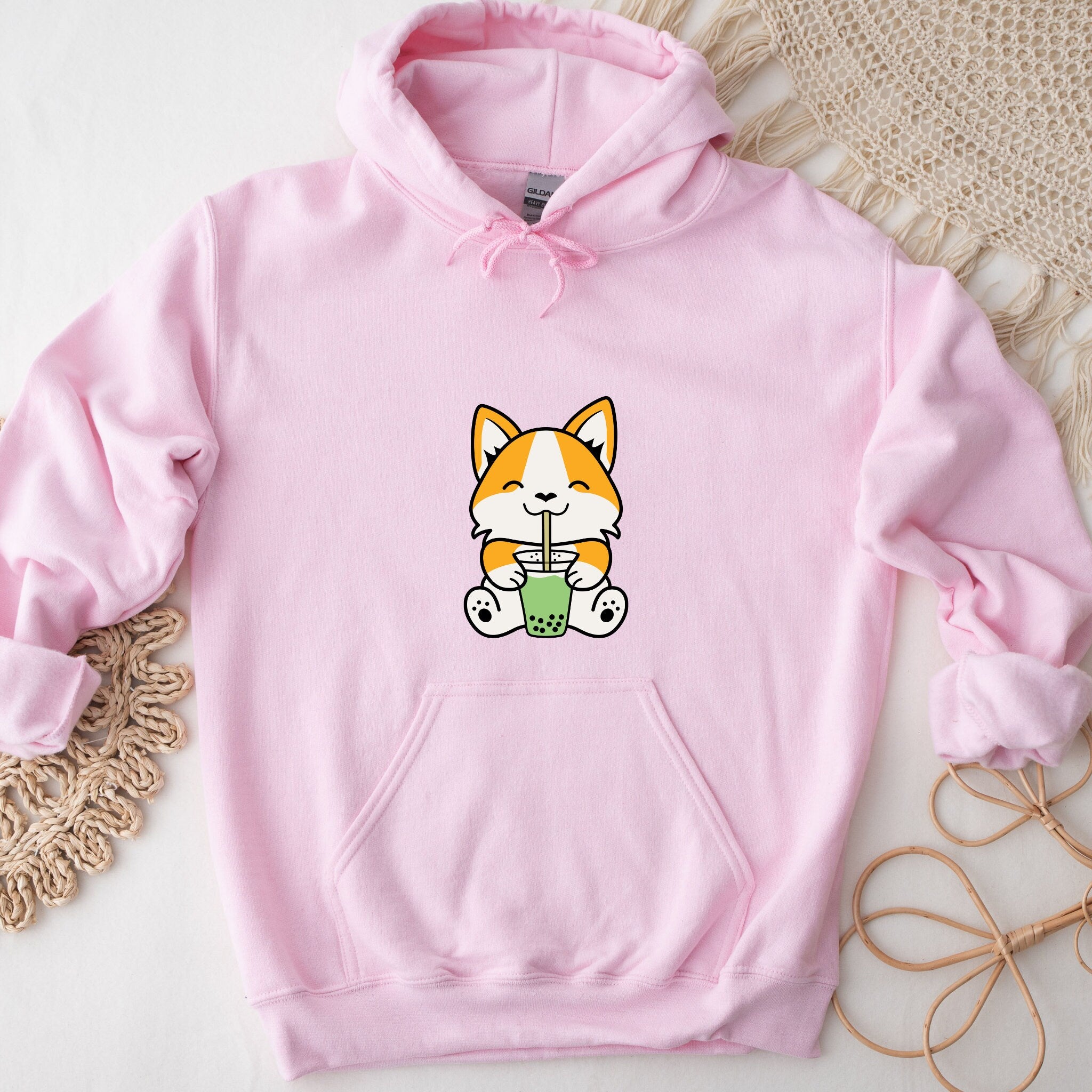 a pink hoodie with a cartoon cat holding a cup of coffee