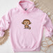 a pink hoodie with a cartoon monkey on it