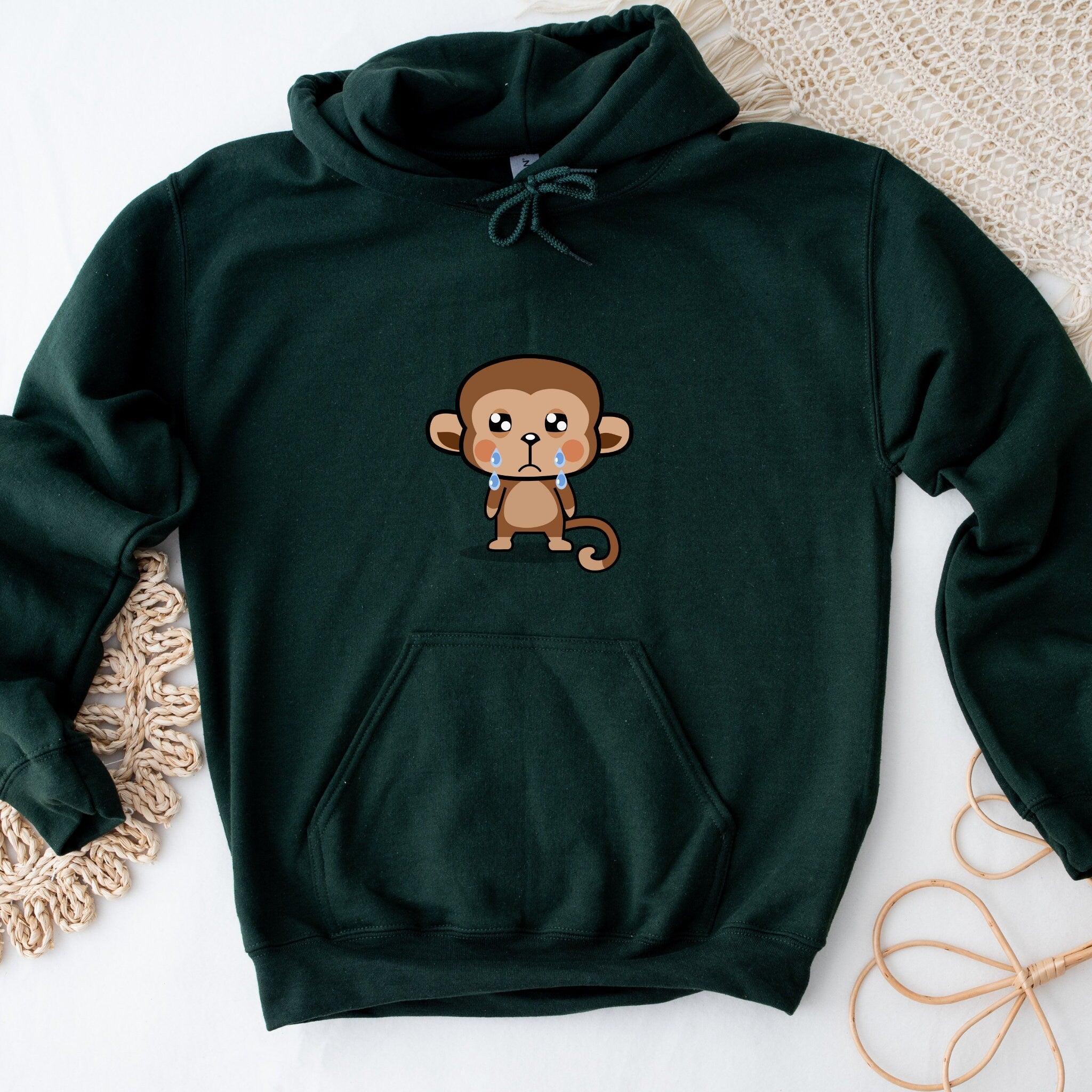 a green hoodie with a cartoon monkey on it