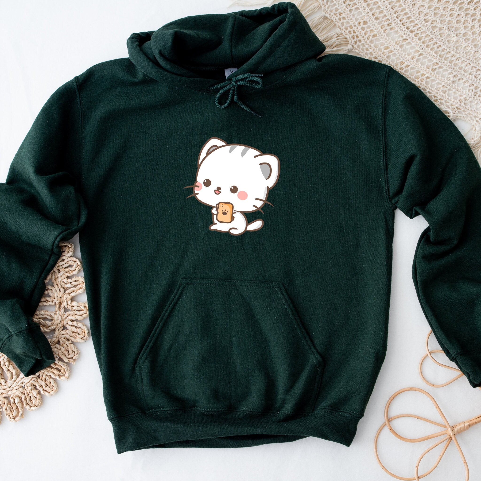 a green hoodie with a white cat on it