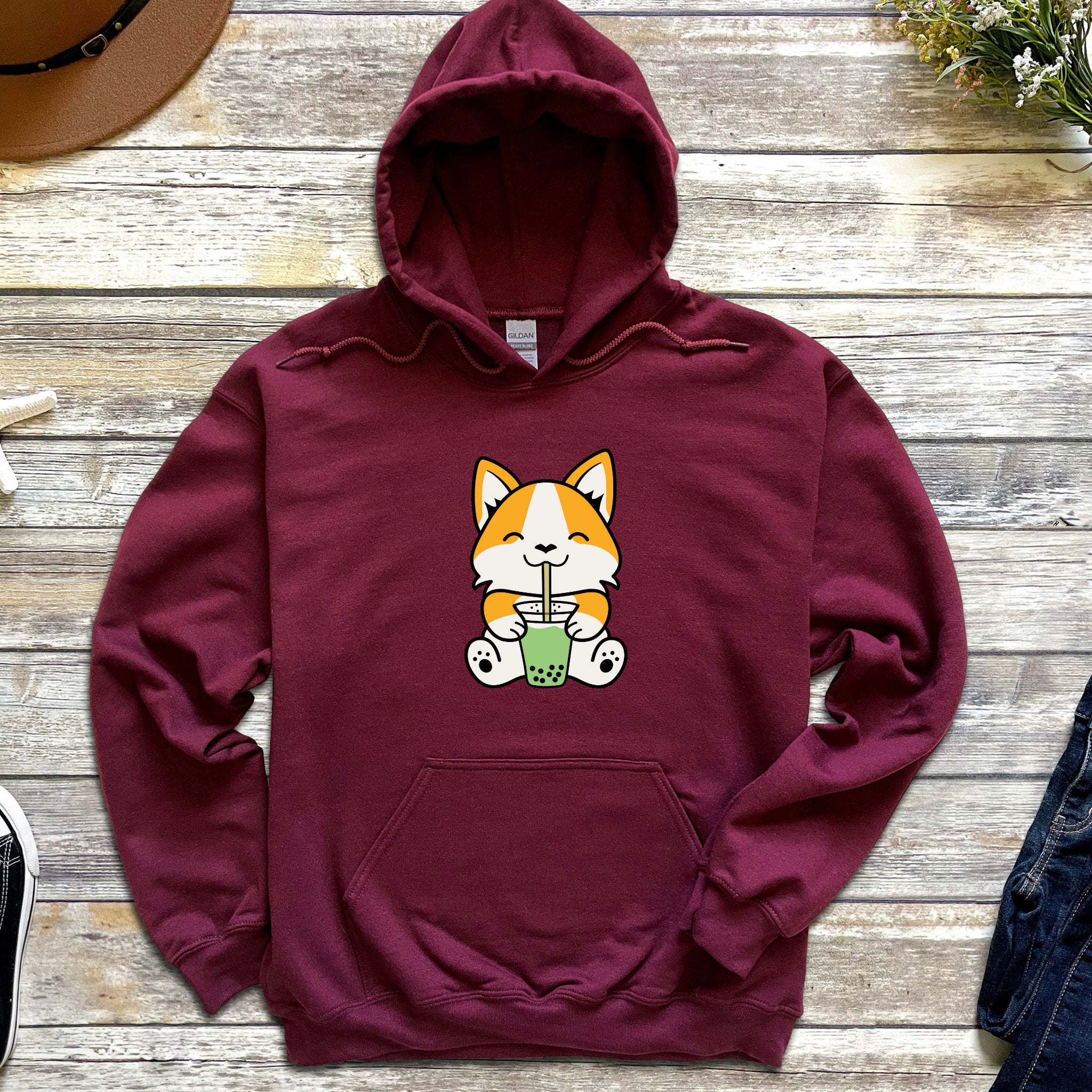 a maroon hoodie with a cartoon cat on it