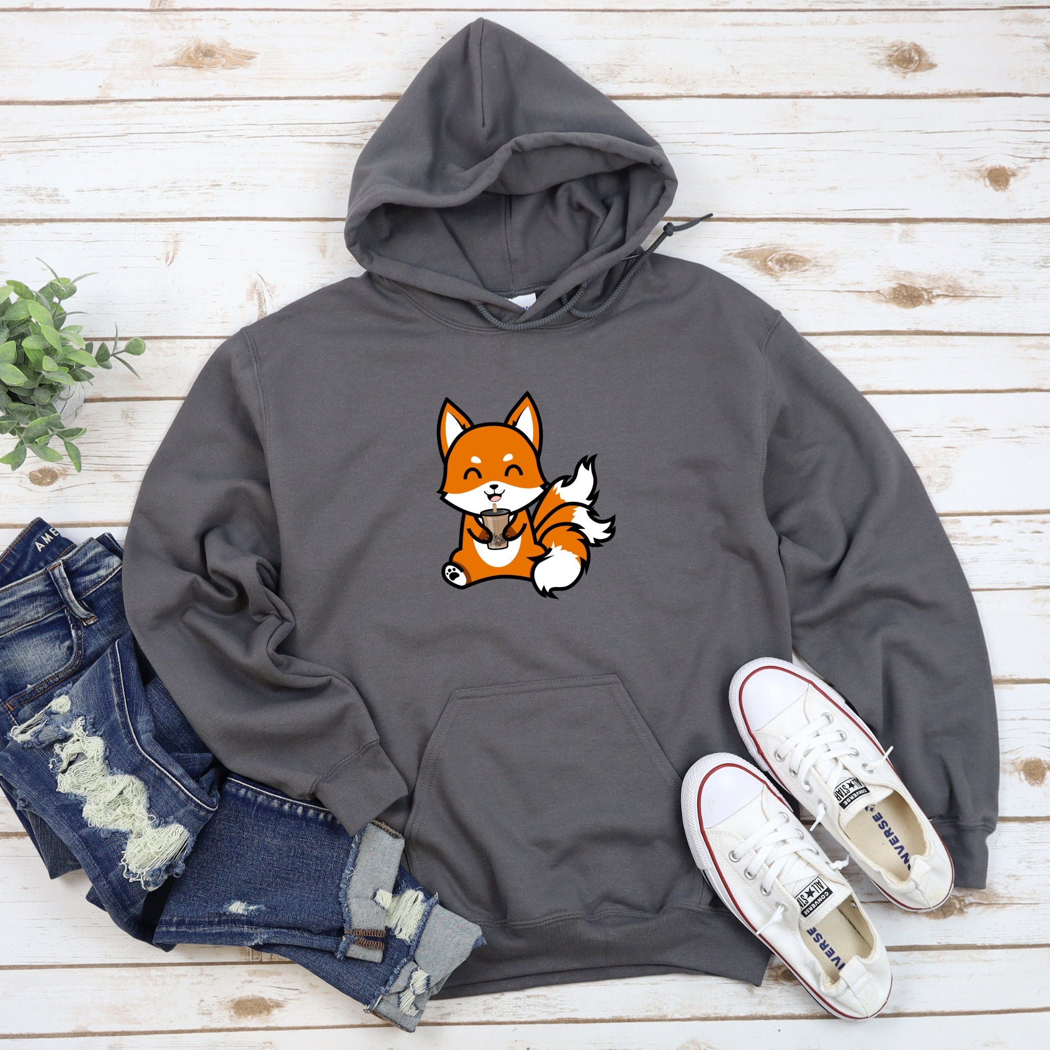 a gray hoodie with a cartoon fox on it