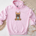 a pink hoodie with a cartoon dog on it