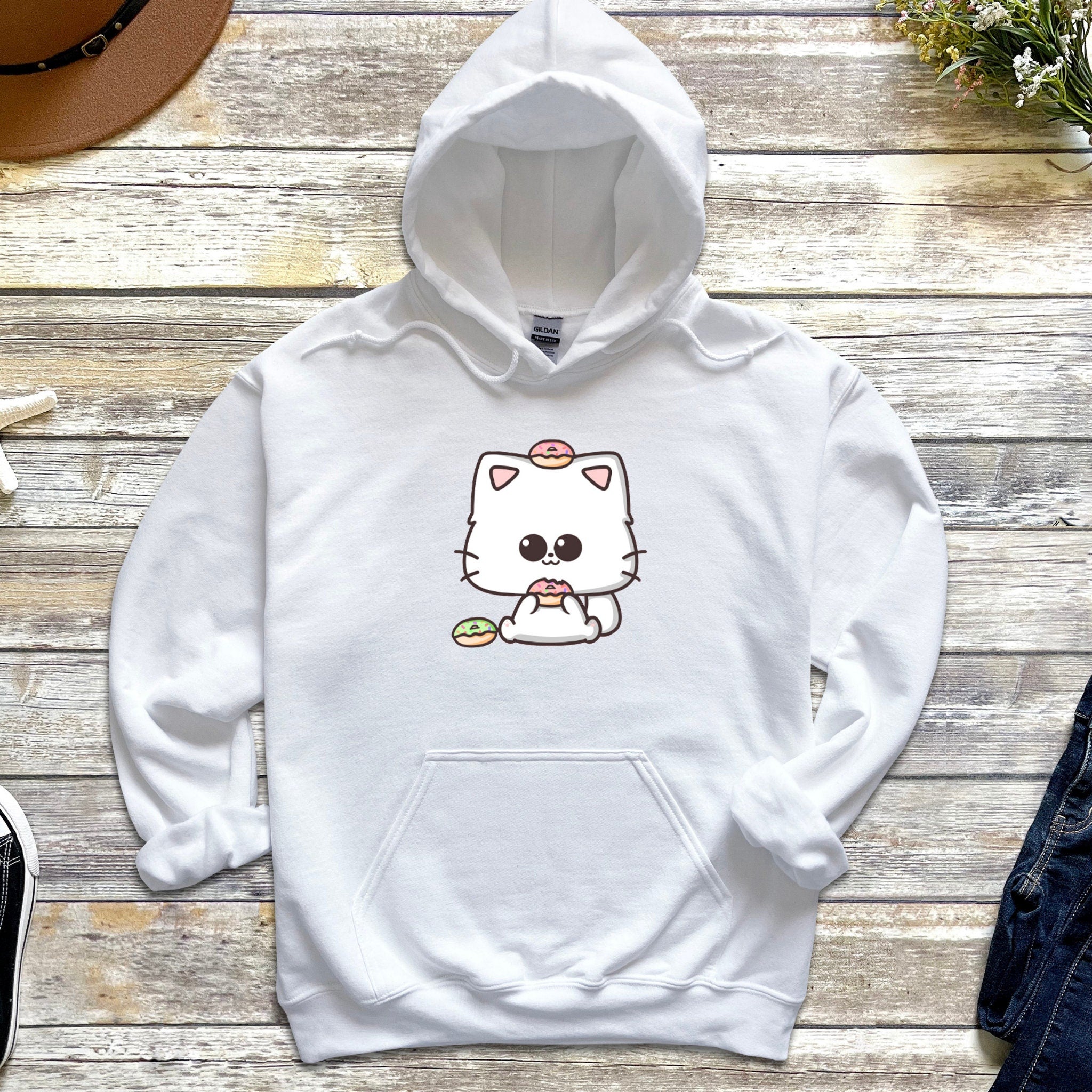a white hoodie with a cat on it