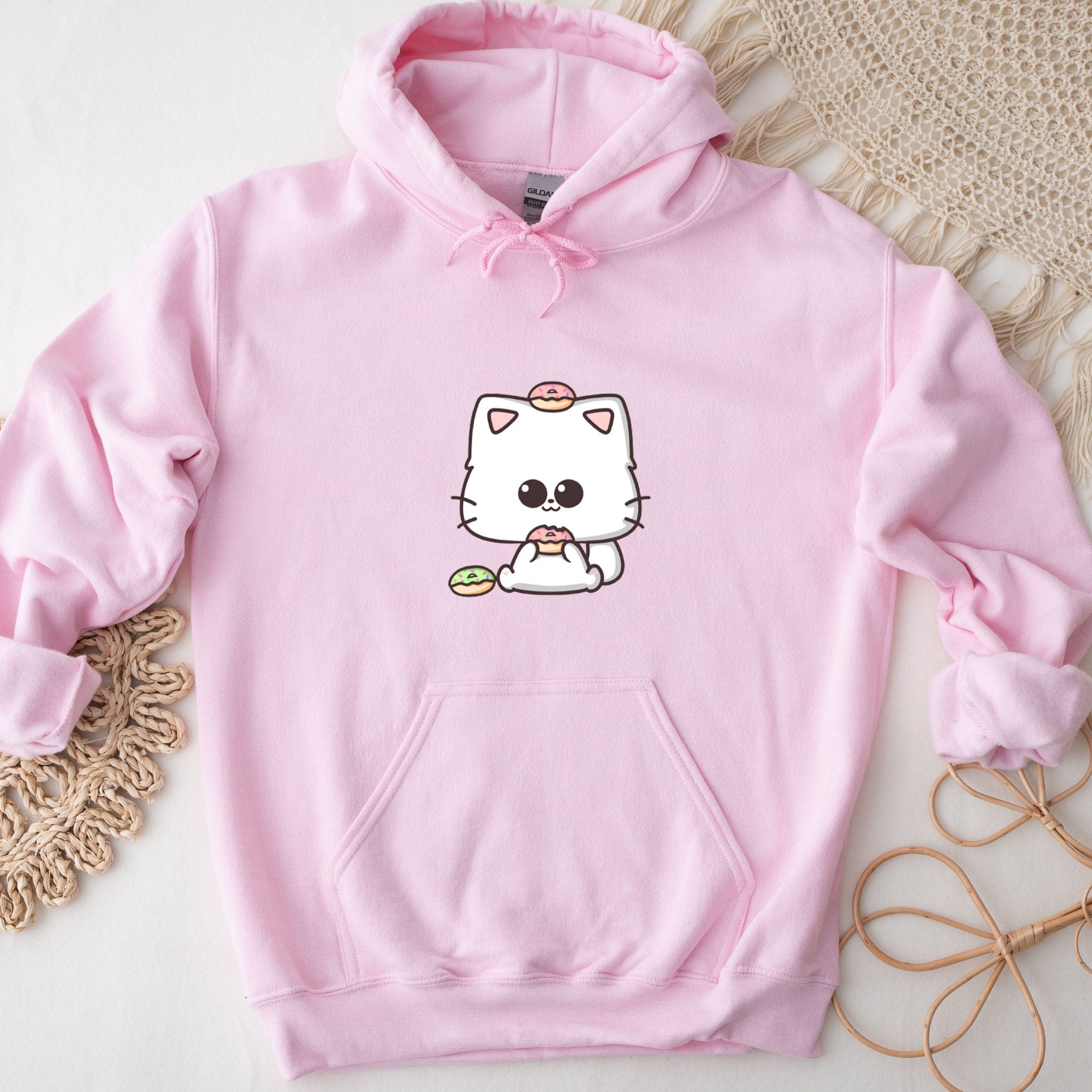 a pink hoodie with a picture of a cat on it