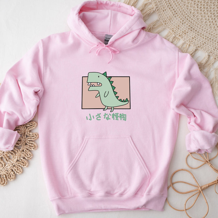 a pink hoodie with a green dinosaur on it