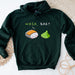 a green sweatshirt with a sushi on it that says wasa bae?