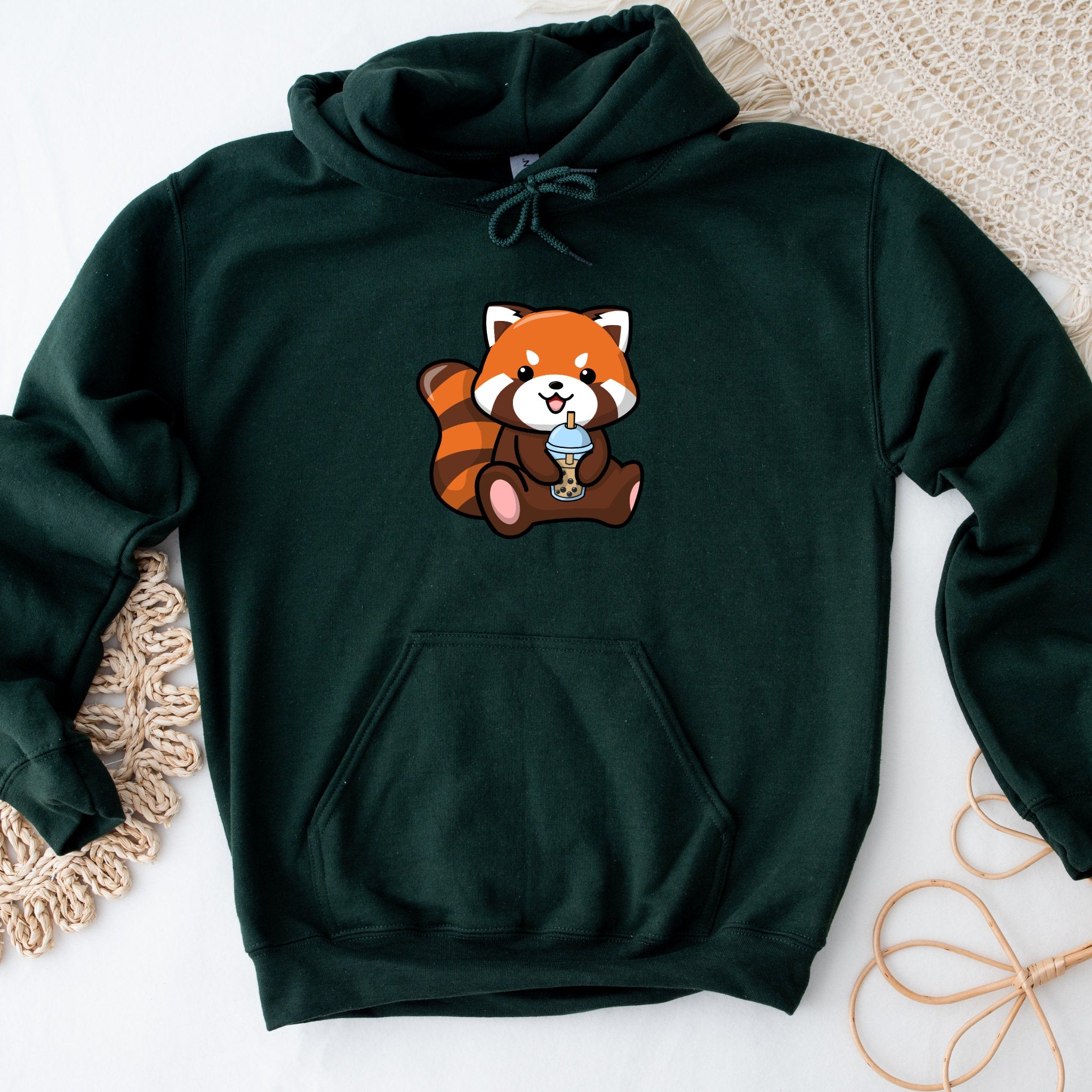a green hoodie with a picture of a red panda holding a cup