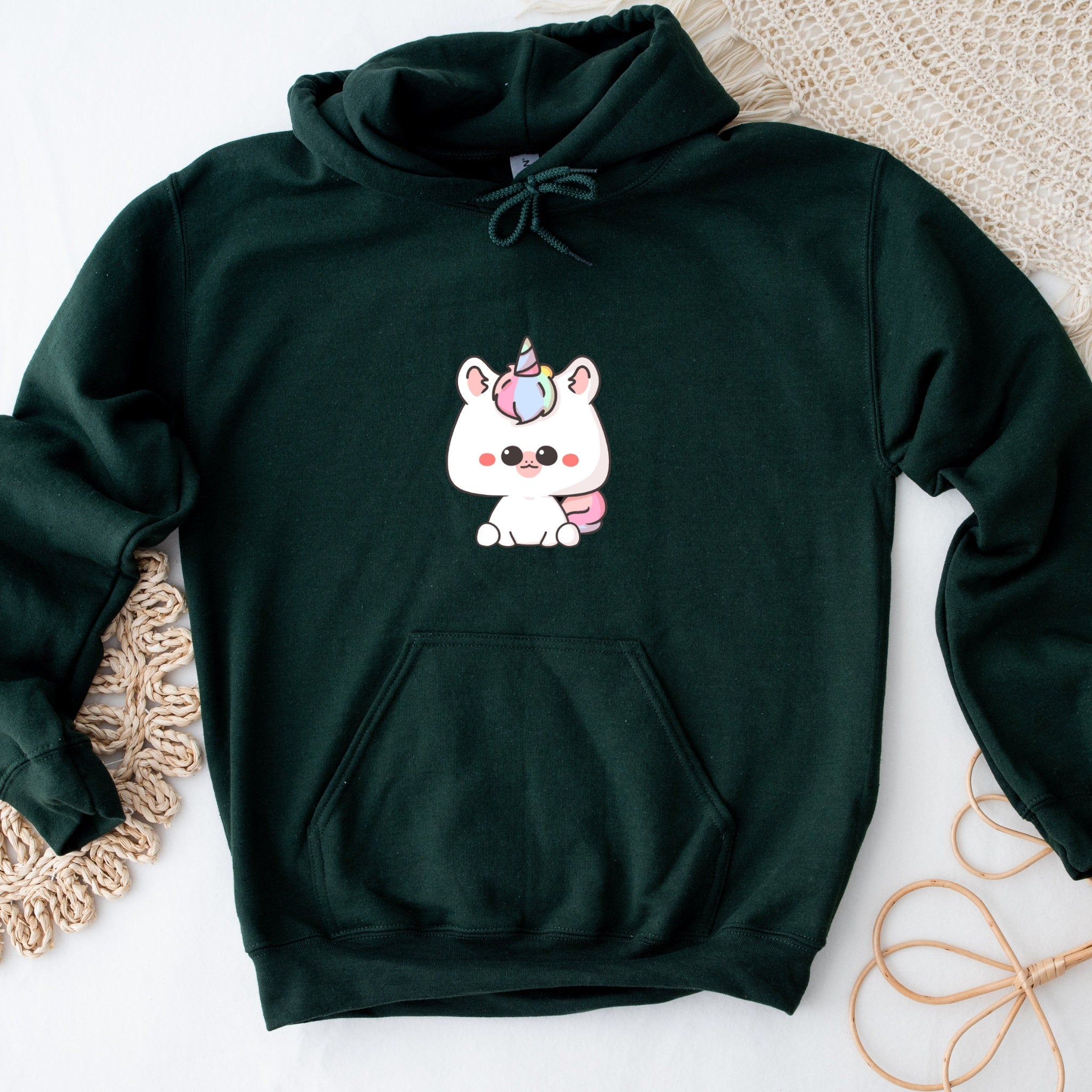 a green sweatshirt with a picture of a unicorn on it