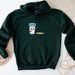 a green hoodie with a picture of a glass of milk and a plate of