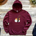 a maroon hoodie with a picture of a cat on it