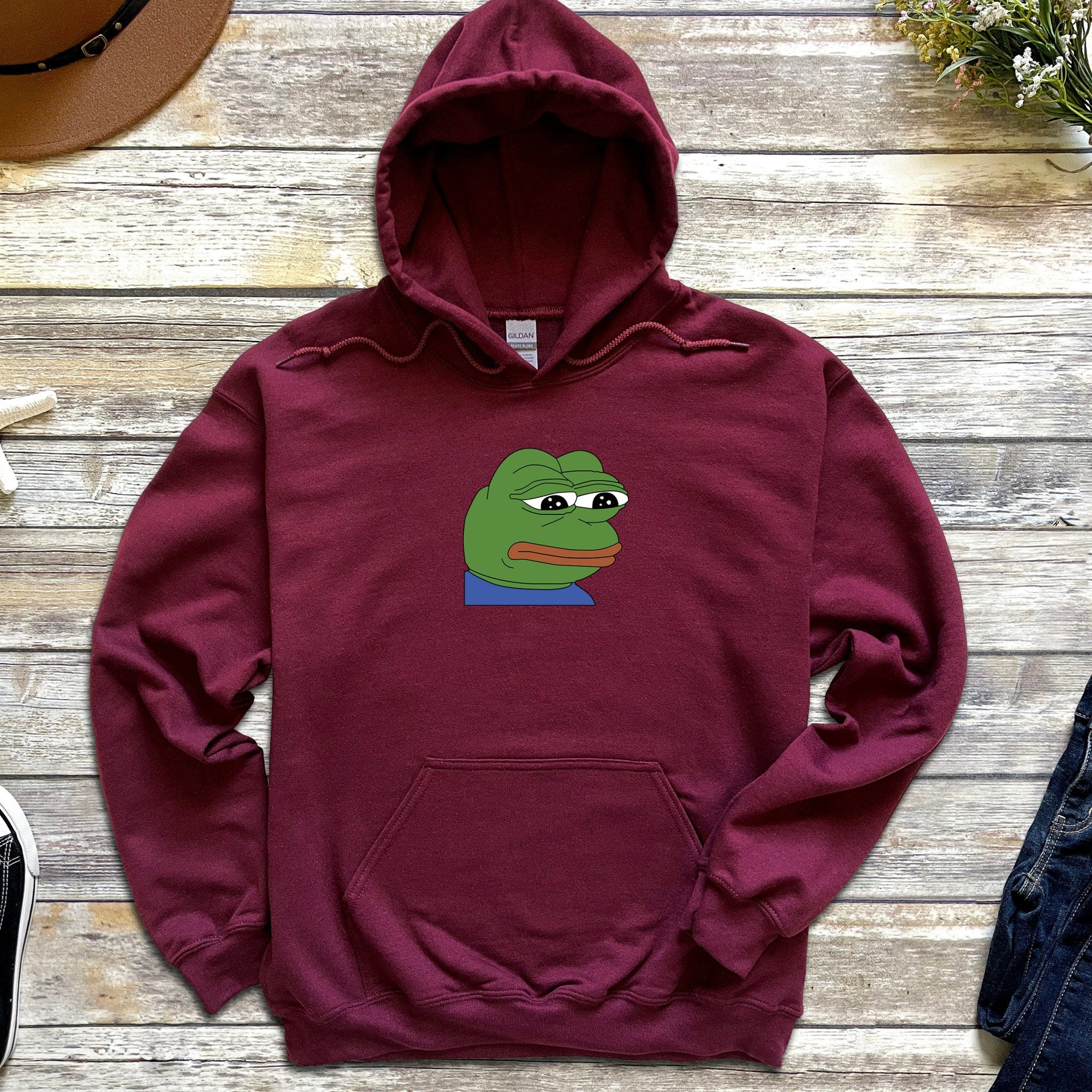 a red hoodie with a green frog on it